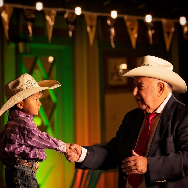 Two generations dancing in cowboy hats at El Ranchero
